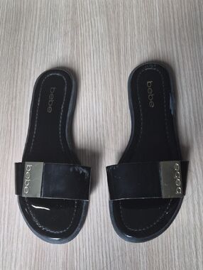 bebe Black Patent Slide Sandals with Gold Logo Plaque
